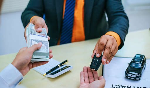 man-passing-cash-and-receiving-suv-keys